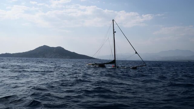 sunken boat in the ocean an island on the scenery