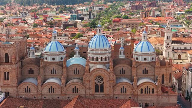 Aerial drone view of the New Cathedral of Cuenca with its iconic blue domes in the historic center of Cuenca, Ecuador.