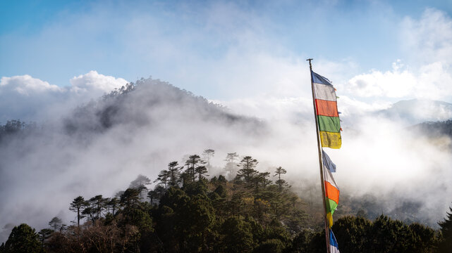 Dochula Pass prayer flags in misty mountain landscape Bhutan 2025
