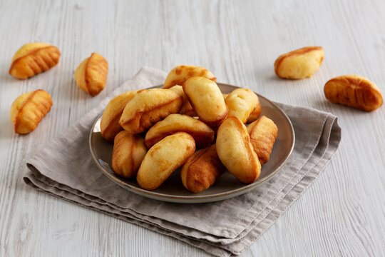 Homemade Sweet French Mini Madeleines on a Plate, side view.