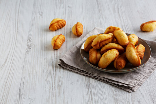 Homemade Sweet French Mini Madeleines on a Plate, side view. Copy space.