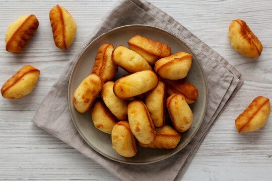 Homemade Sweet French Mini Madeleines on a Plate, top view.