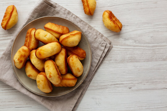 Homemade Sweet French Mini Madeleines on a Plate, top view. Copy space.