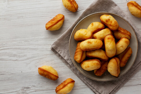 Homemade Sweet French Mini Madeleines on a Plate, top view. Copy space.