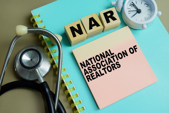 Concept of NAR - National Association of Realtors write on sticky notes isolated on Wooden Table.