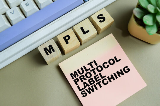 Concept of MPLS - Multi Protocol Label Switching write on sticky notes isolated on Wooden Table.