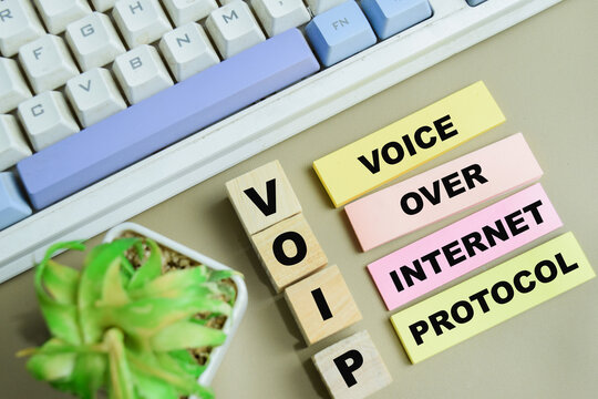 Concept of VOIP - Voice Over Internet Protocol write on sticky notes isolated on Wooden Table.