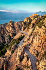 Naklejka premium Winding mountain road through Calanques de Piana in France 2024