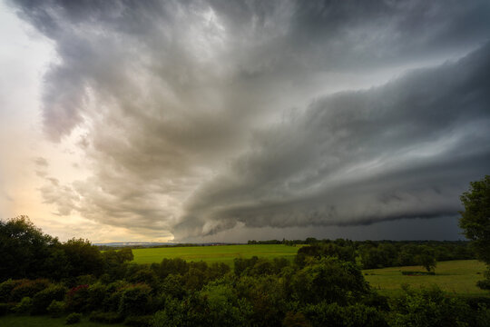 Dramatic storm clouds over lush green fields in Bavaria Germany 2024