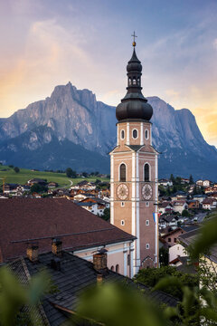 Stunning church tower in Castelrotto with Dolomites mountain backdrop 2024