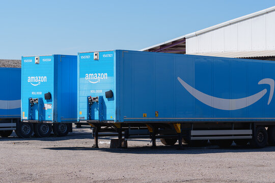 Dusseldorf, Germany - August 8 2026: Amazon trailers stand beside a warehouse, showing branded logistics equipment