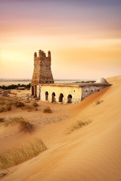 Ancient stone architecture and minaret buried in desert sand in Chinguetti, Mauritania, 2025