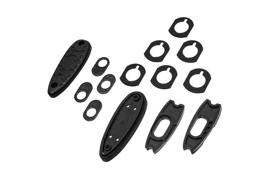 Black shotgun recoil pad and stock shim set isolated on white back
