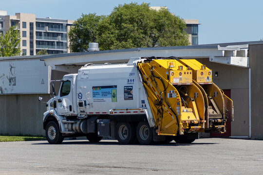 Ottawa, Canada - July 30, 2026: City Ottawa municipal garbage truck parked near building