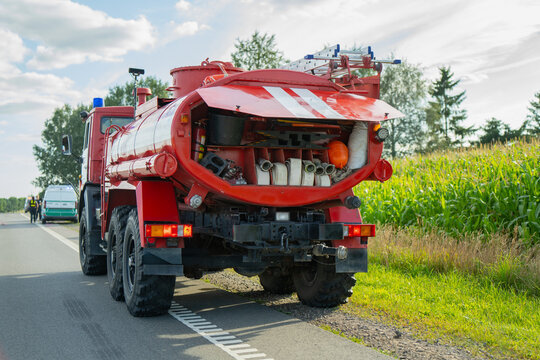 Rear view of fire tanker truck with open compartment displaying fire hoses and firefighting equipment representing emergency response and public safety