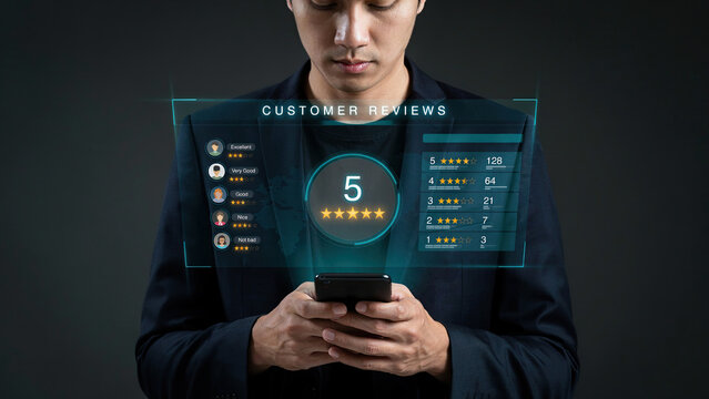 Businessman holding mobile phone with holographic interface showing customer reviews and five star rating system