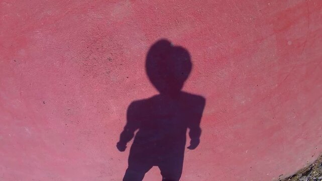 silhouette of a young man. shadow of a guy in a Panama hat. strong wind
