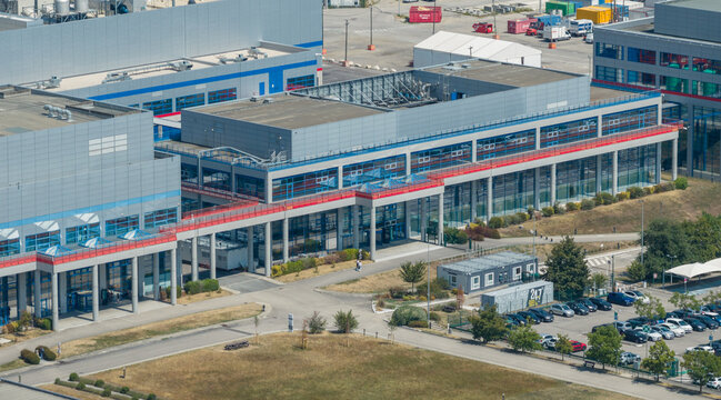 Crolles, France - 01 August 2026: Aerial view of the STMicroelectronics semiconductor manufacturing campus, featuring modern office buildings, the main entrance, and employee parking areas.