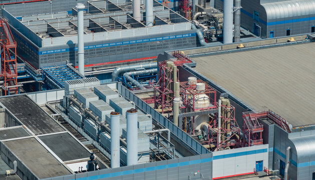 Crolles, France - 01 August 2026: Aerial view of the STMicroelectronics semiconductor manufacturing campus, showing process exhaust treatment equipment, cooling units, and ventilation stacks.