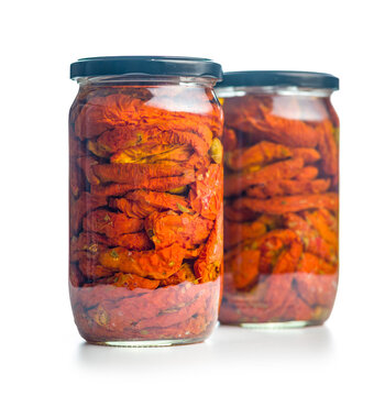 Jar Of Sun-Dried Tomatoes Preserved In Oil Close-Up On White Background