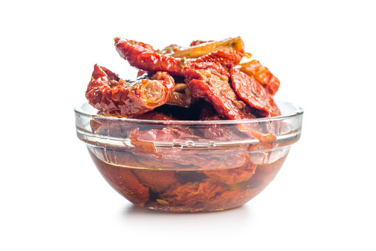 Sun-Dried Tomatoes in Olive Oil in a Glass Bowl Close-Up on White Background