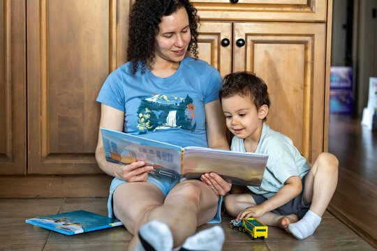 Mother and Young Son Reading Together at Home During Cozy Storytime and Playful Bonding Moment