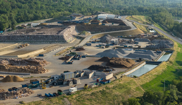 Saint-Quentin-sur-Isere, France - 02 August 2026: Aerial view of a waste management complex featuring a landfill, recycling plant, biomass storage, and industrial infrastructure.