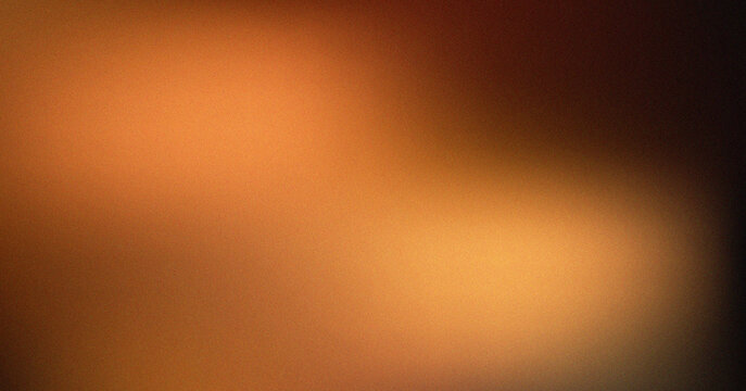 Abstract smooth golden orange gradient light glow with a soft grainy texture for artistic creative designs