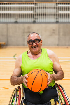 Senior man smiling playing wheelchair basketball