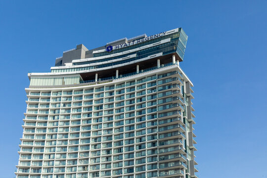 Nha Trang, Vietnam - 27.03.2026: Modern high-rise Hyatt Regency hotel building with unique architectural design against a clear blue sky in an urban environment and roof top swimming pool