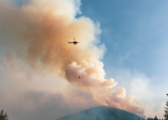 Helicopter Carrying Water Bucket Over Smoke From Wildfires Near Hope, BC, Canada © edb3_16