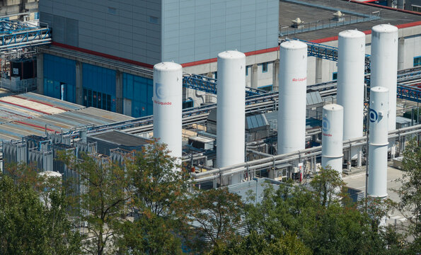 Crolles, France - 01 August 2026: Aerial view of Air Liquide cryogenic gas storage tanks at the STMicroelectronics facility, featuring industrial piping and infrastructure.