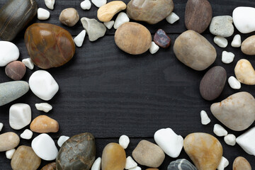White pebble stones on wooden background, top view © Liami