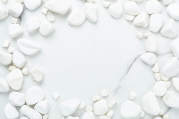 White pebble stones on marble background, top view © Liami