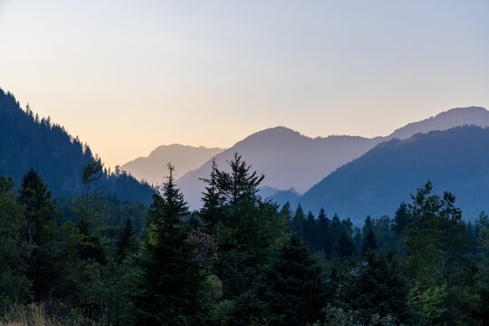 Misty Mountain Sunrise Over Forested Peaks Near Hope Slide, Hope BC Canada &mdash; Serene Valley Landscape