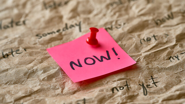 Vibrant pink sticky note with 'NOW!' message, pinned to crumpled brown paper with procrastination words. Focus on urgency