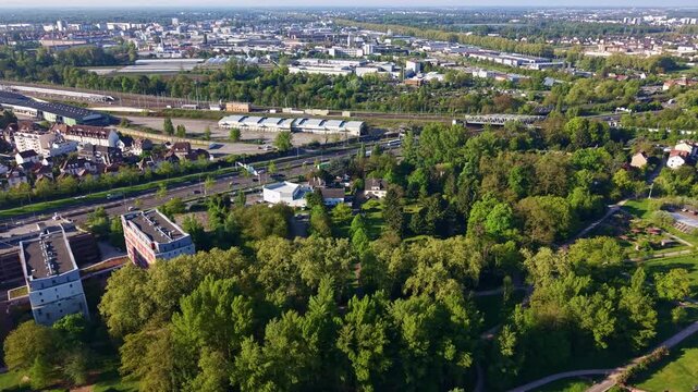 Route Nationale 4 highway, railway line, and commercial area in Strasbourg, France. Aerial forward