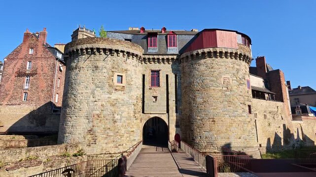 Medieval stone city gate Portes Mordelaises with twin towers and bridge entrance in Rennes, France