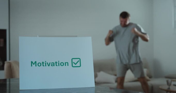 Motivated man celebrating with confidence at home. Ideal for success, motivation, achievement, productivity, and positive mindset concepts.