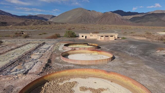Drone flyby dolly of circular settling tanks at abandoned aluminum sulfate plant, Calingasta, drone