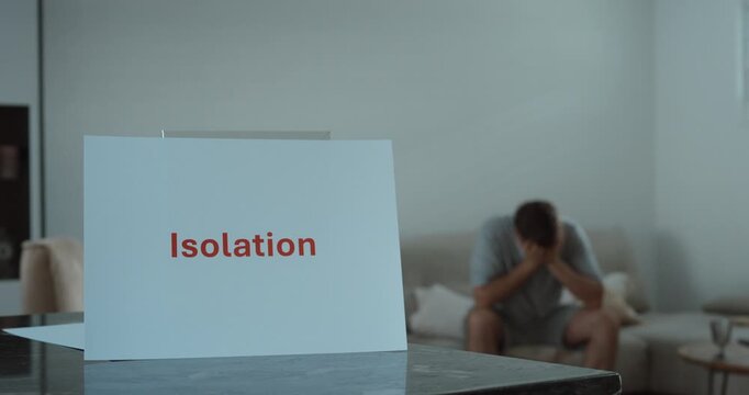 Man sitting alone with his head in his hands, representing isolation and loneliness. Ideal for mental health, depression, and emotional wellbeing concepts.