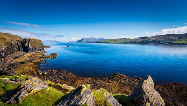 stunning rugged rocky scottish coastline landscape overlooking loch striven into the clear cold blue water firth of clyde on a gorgeous sunny day
