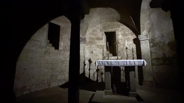 Ancient stone altar in dark crypt of Nepi Duomo, Italy