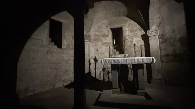 Stone altar in dark crypt of Nepi Duomo, Italy