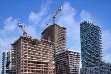 Fototapeta premium Modern high rise apartment buildings under construction