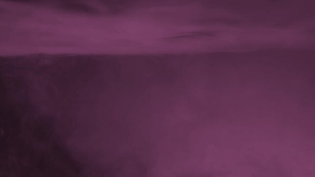 Gentle pink fog cloud hovering over top edge of dark black background frame