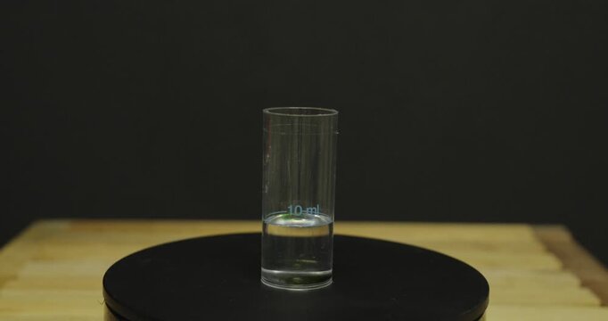 Performing a water hardness test using a drop test kit. Ideal for water quality, limescale, laboratory, and home testing concepts.