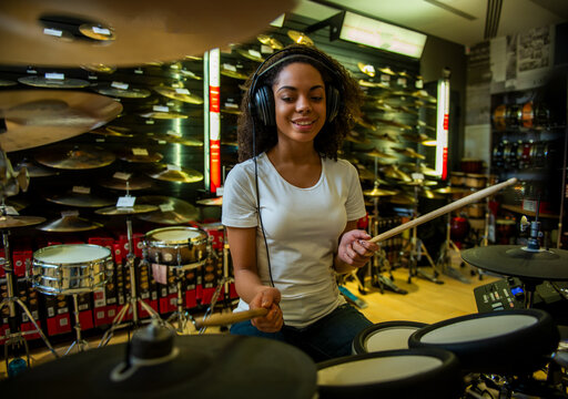 Woman Testing Electronic Drums.
