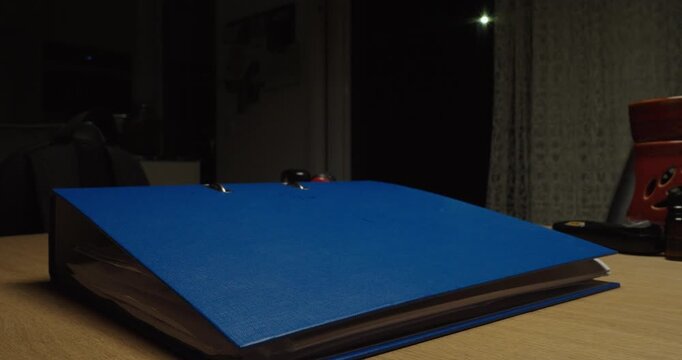 Office binder being thrown onto a table. Ideal for work stress, frustration, paperwork overload, office pressure and administrative problems.