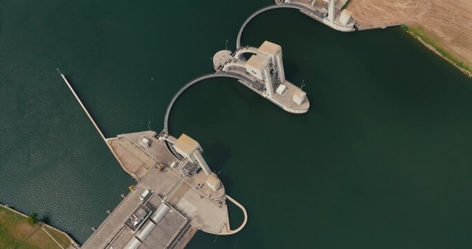 Drone pushes toward the Maurik hydroelectric power plant on the Lower Rhine, highlighting its distinctive circular dam and renewable energy infrastructure from above.